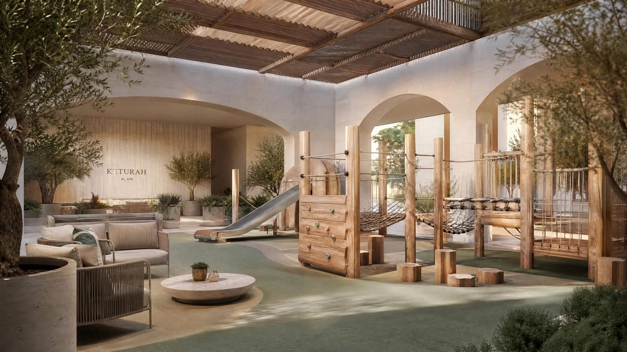 A children's discovery play area shaded within a landscaped court.