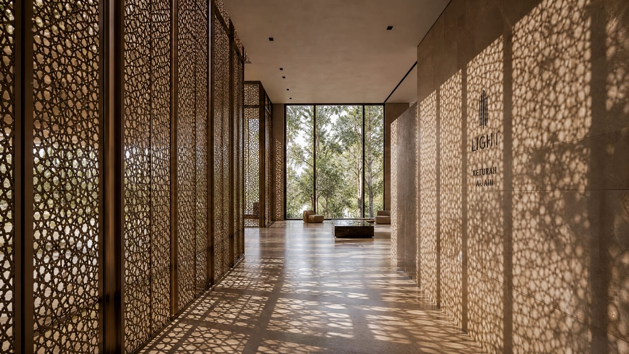 Desert light filtered through a carved screen across a stone interior.