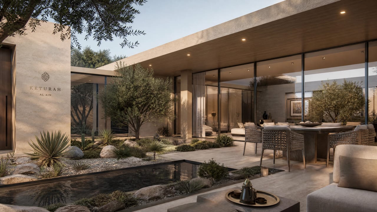 A private villa courtyard with Keturah signage, glass-walled living and dining opening to olive trees and a reflecting pool.
