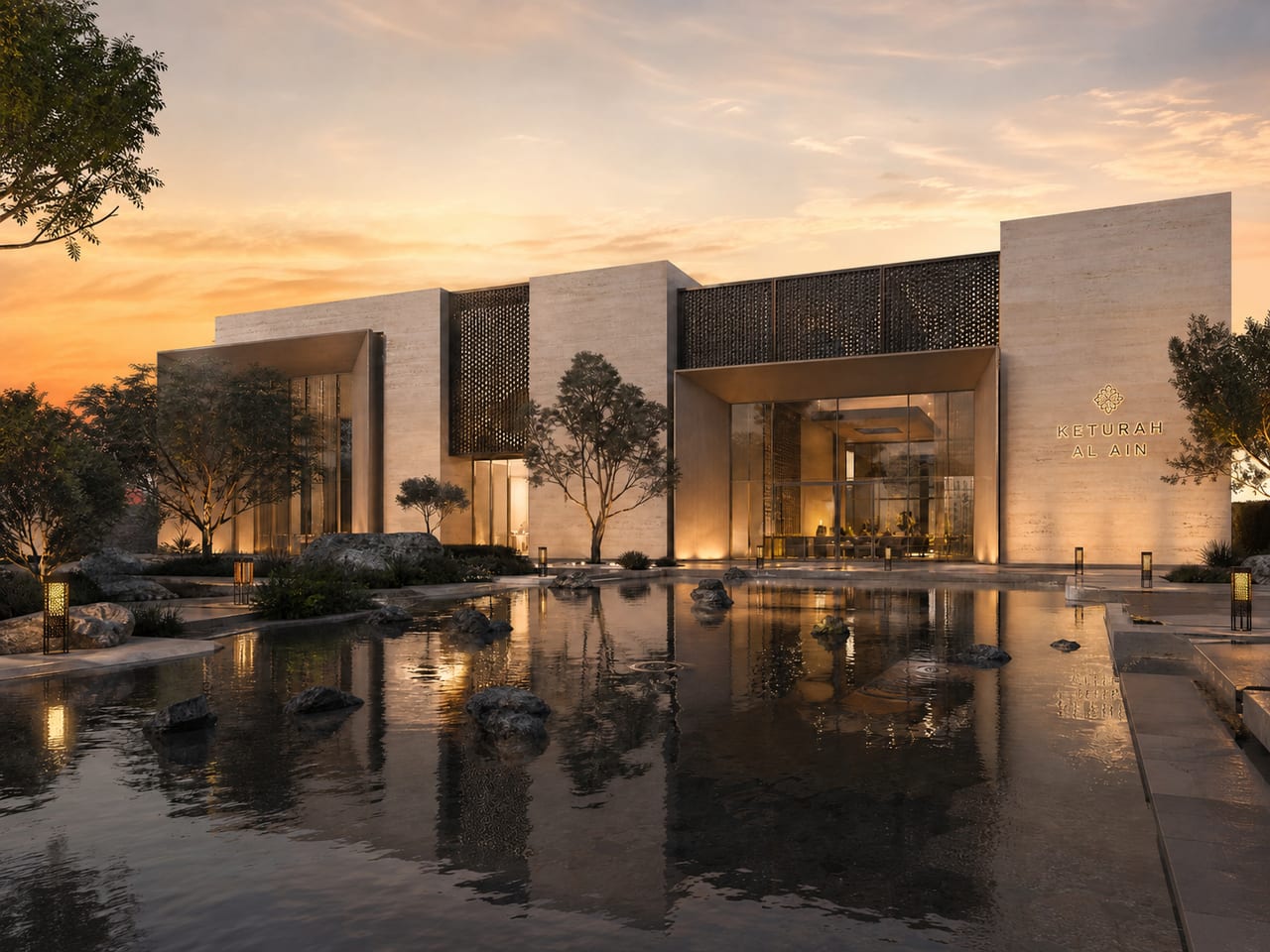 The wellness reserve at sunset, its stone volumes and carved screens mirrored in a still reflecting pool.